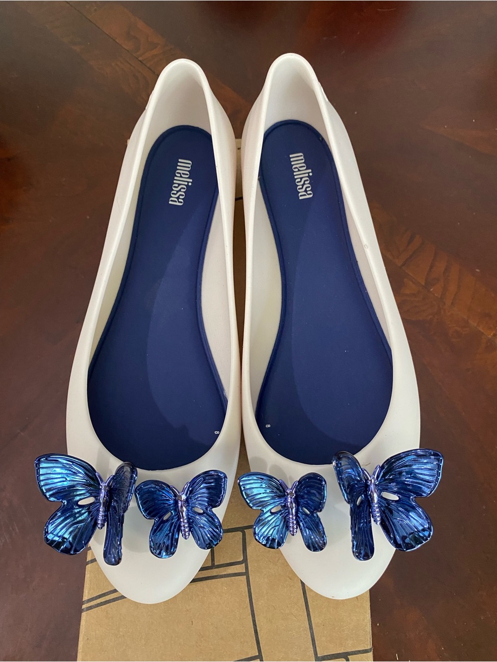 Melissa White Flats with Metallic Blue Butterfly Ornaments